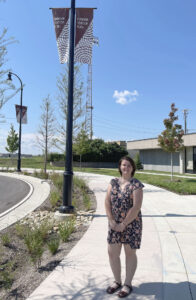 Brilee Wright in front of the banners she designed