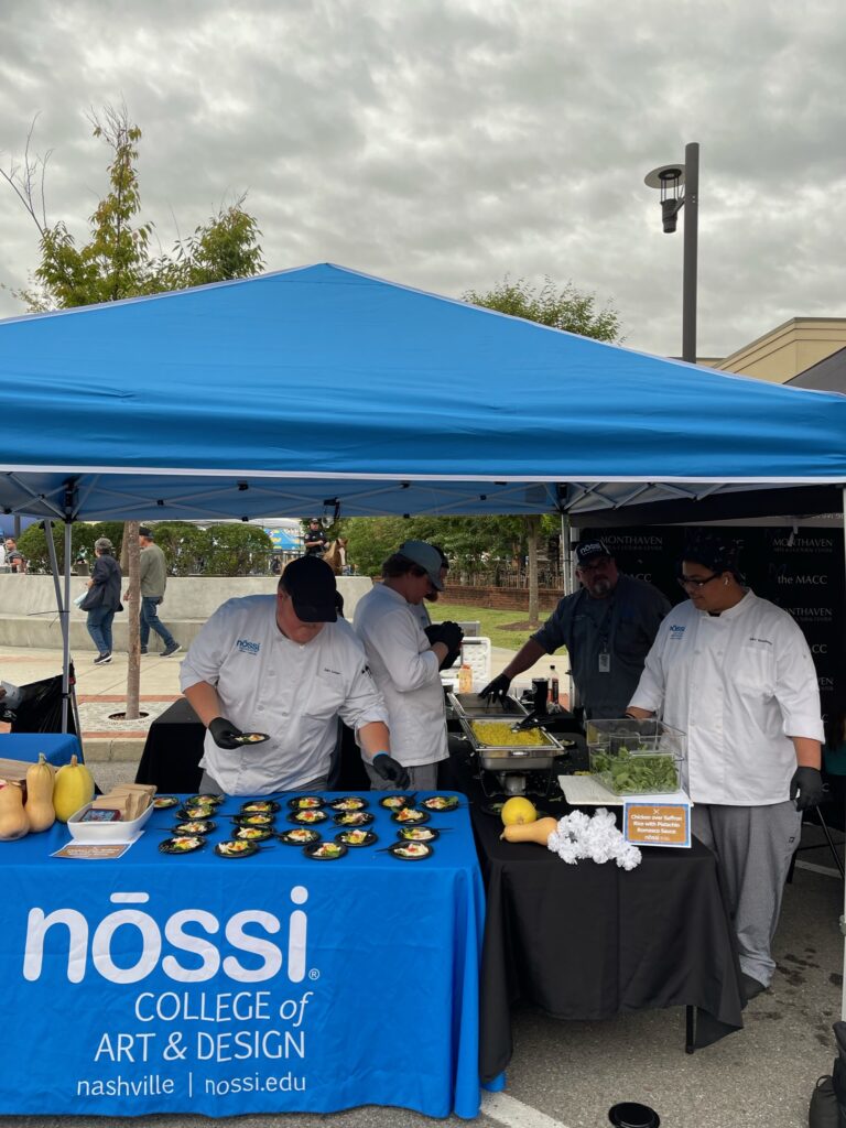 Nossi culinary students at the Taste of Hendersonville handing out samples they cooked.