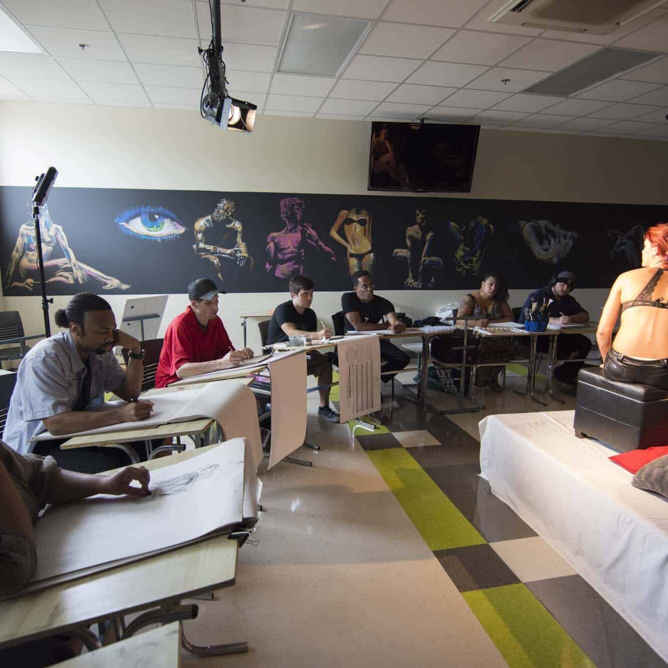 Anatomy Studio Illustration student sketching concept art in a creative classroom at Nossi College of Art & Design